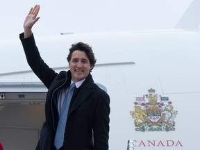 Prime Minister Justin Trudeau waves as he boards a government plane, Monday, January 9, 2023 in Ottawa.  THE CANADIAN PRESS/Adrian Wyld