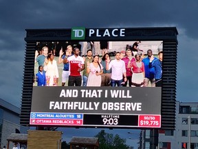 Twenty-five of Canada’s newest citizens are sworn in at special citizenship ceremony hosted by the Ottawa RedBlacks during half-time of their game against the Montreal Allouettes. Hafsatou Balde