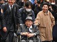 Iwao Hakamada, centre, is accompanied by his sister Hideko, right, and supporters as they enter the Tokyo High Court on March 13, 2023.