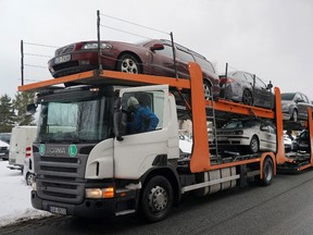 A trailer loaded with vehicles to send to Ukraine, which were confiscated from drunk drivers, in Riga, Latvia, March 8, 2023.