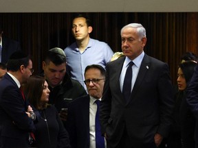 Israeli Prime Minister Benjamin Netanyahu attends a meeting at the Knesset, Israel's parliament, amid demonstrations after he dismissed the defence minister as his nationalist coalition government presses on with its judicial overhaul, in Jerusalem, March 27, 2023. Netanyahu is discussing a visit to the U.S., but no invitation has been made.