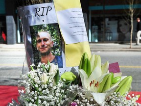 Flowers adorn a memorial to Paul Stanley Schmidt, a 37-year-old father who was stabbed to death outside a Starbucks coffee shop in downtown Vancouver on March 26, 2023.