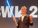 Disney Parks and Experiences Chairman Josh D’Amaro shows off a 'real' lightsaber.
