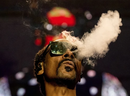 FILE - US rapper Calvin Cordozar Broadus Jr aka Snoop Dogg blows smoke as he performs on stage at the Accor Arena of Bercy, in Paris, on March 25, 2023. PHOTO BY ANNA KURTH/AFP VIA GETTY IMAGES