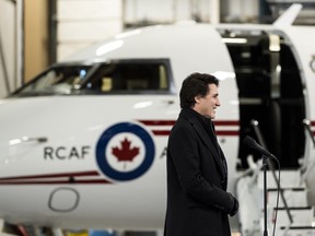 Prime Minister Justin Trudeau speaks to reporters at the Ottawa airport before getting on one of the Bombardier Challenger 650 business jet he uses for flying within Canada, January 29, 2023.