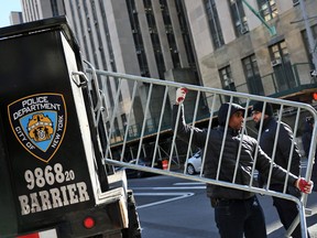 NYPD drop off metal barricades in front of Manhattan Criminal Court in New York City ahead of the possible arrest of former president Donald Trump, March 20, 2023.