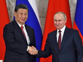 Russian President Vladimir Putin and China's President Xi Jinping shake hands in Moscow, March 21, 2023.