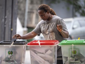 A woman casts her vote at a polling station in Lagos, Nigeria Saturday, Feb. 25, 2023. Voters in Africa's most populous nation are heading to the polls Saturday to choose a new president, following the second and final term of incumbent Muhammadu Buhari.