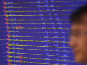 Earthquake and Volcano of the Korea Monitoring Division Director Ryoo Yong-gyu speaks in front of a screen showing seismic waves that were measured in South Korea, in Seoul, South Korea, Friday, Sept. 9, 2016.