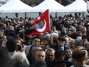 A man holding a flag with an image of Turkey's founder Mustafa Kemal Ataturk waits with others as Kemal Kilicdaroglu, the leader of the pro-secular, center-left Republican People's Party, or CHP, is nominated by a six-party alliance as its common candidate to challenge President Recep Tayyip Erdogan, in Ankara, Turkey, March 6, 2023. The alliance on Monday nominated main opposition party leader Kilicdaroglu to challenge Erdogan in elections in May, ending months of uncertainty and bickering that had frustrated their supporters.