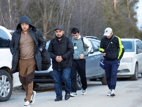 Migrants walk down Roxham Road in Champlain, New York, to cross into Canada on March 24, 2023. Roxham Road saw nearly 40,000 crossings in 2022 alone, but the total number of asylum claimants processed by the Canada Border Services Agency and IRCC in the past year were nearly 92,000.
