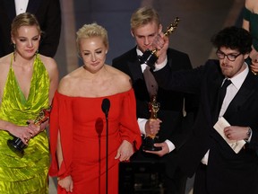 Yulia Navalny, wife of jailed dissident Alexei Navalny, speaks next to her daughter Daria and director Daniel Roher after 'Navalny' was awarded for Best Documentary Feature Film during the Oscars show at the 95th Academy Awards in Hollywood, Los Angeles, California, U.S., March 12, 2023.