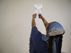 Crystal Kornickey holds up casts of her hands in a studio at the Gibbes Museum of Art in Charleston, S.C., on Thursday, Feb. 16, 2023.