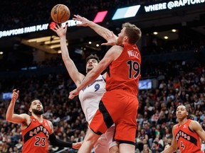 Washington Wizards forward Deni Avdija (9) is defended by at the net by Toronto Raptors centre Jakob Poeltl (19) during first half of their NBA game in Toronto on Sunday, Mar. 26, 2023.