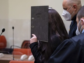 FILE - Defendant Jennifer W. arrives in a courtroom for her trial in Munich, Germany, Oct. 25, 2021. A German appeals court orders on Thursday, March 9, 2023, a new sentencing hearing for the German convert to Islam who was given 10 years in prison on charges that, as a member of the Islamic State group in Iraq, she allowed a 5-year-old Yazidi girl she and her husband kept as a slave to die of thirst in the sun.