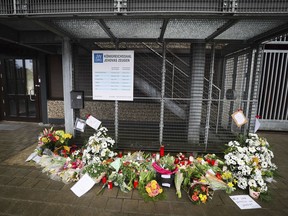 Flowers and candles are placed in front of the entrance to a Jehovah's Witness community center in Hamburg, Germany, Monday, March 13, 2023. Authorities say one victim's life is still in danger after last week's shooting at a Jehovah's Witness hall in Hamburg in which a former member of the congregation killed six people and then himself.