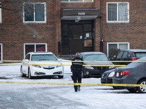 Police investigate the scene where two officers were shot and killed on duty in Edmonton on Thursday, March 16, 2023.