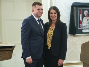 Alberta Jobs Minister Brian Jean stands with Alberta Premier Danielle Smith after being sworn into cabinet in Edmonton on Monday, Oct. 24, 2022. The Alberta government has started a second campaign aimed at attracting skilled workers from Ontario and Atlantic Canada.