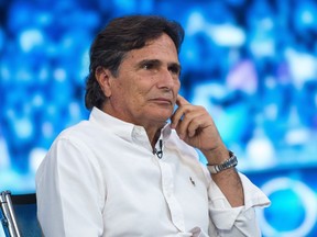 FILE - Three-time world champion Formula One racer Nelson Piquet of Brazil attends the shooting of the Hungarian Television's Formula One magazine in Budapest, Hungary, on July 23, 2015. Retired Formula One champion Nelson Piquet has been ordered to pay $950,000 for making racist and homophobic comments about Lewis Hamilton.