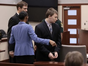 FILE - Aiden Fucci is directed to his seat by his attorneys as he entered the Saint Johns County Courtroom of Judge R. Lee Smith, St. Augustine, Fla. The judge sentenced Fucci to life in prison on Friday, March 24, 2023 for fatally stabbing a 13-year-old classmate on Mother's Day in 2021.