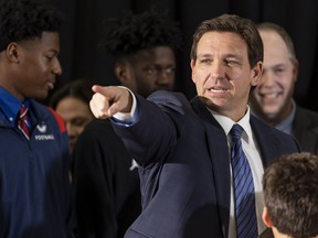 Florida Governor Ron DeSantis takes questions from the media during a press conference at Christopher Columbus High School on Monday, March 27, 2023, in Miami, Fla. The press conference was held to announce DeSantis's signing of a private school voucher expansion, HB1, which allows more Florida school children become eligible for taxpayer-funded school vouchers.