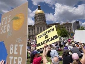 FILE - Abortion rights protesters rally near the Georgia state Capitol in Atlanta on May 14, 2022. Georgia's highest court is considering whether the state's restrictive abortion law is void because it violated U.S. Supreme Court precedent that was in effect at the time when it was enacted.