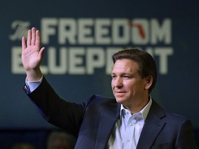 Florida Gov. Ron DeSantis waves to the crowd as he attends a campaign event Friday, March 10, 2023, in Davenport, Iowa.
