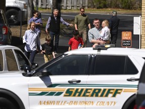 Families leave a reunification site in Nashville, Tenn., Monday, March 27, 2023 after several children were killed in a shooting at Covenant School in Nashville. The suspect is dead after a confrontation with police.