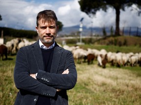 Gabriel Zuchtriegel, director of the Pompeii archaeological park, poses with his ovine assistants.