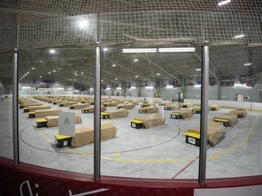 Beds and bins for personal belongings sit on an ice rink that has been converted into a temporary shelter for single men at Jim Durrell Arena in Ottawa, during the COVID-19 pandemic on Wednesday, April 29, 2020.&ampnbsp;Ottawa is turning to its pandemic-era temporary shelters to house vulnerable populations while the city searches for a long-term plan to find permanent homes.&ampnbsp;THE CANADIAN PRESS/Justin Tang