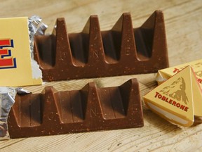 Two bars of the Toblerone Swiss chocolate are shown, at front is the new style 150 gram bar showing the reduction in triangular pieces, in the background is the older style 360 gram bar, pictured in London, on Nov. 8, 2016. The makers of Toblerone are stripping images of Switzerland's famed Matterhorn and the Swiss flag from the packaging of the milk-chocolate treat to comply with "Swissness" legislation, largely because some of its production is being outsourced to Slovakia. Mondelez International of Deerfield, Illinois, which owns the Swiss-born brand, said Monday March 6, 2023, it's in the process of adapting the packaging of Toblerone products to conform with Swiss law.