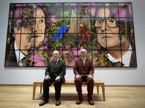 Gilbert and George sit with their artwork called On The Bench in their exhibition called The Paradisical Pictures at the opening of The Gilbert & George Centre in east London, Friday, March 24, 2023.