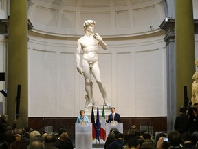 FILE - German Chancellor Angela Merkel, left, and Italian Prime Minister Matteo Renzi speak during a press conference in front of Michelangelo's "David statue" after their bilateral summit in Florence, Italy, on Jan. 23, 2015. The head of Florence's Galleria del'Accademia on Sunday March 26, 2023 invited the parents and students of a Florida charter school to visit and see Michelangelo's "David," after the school principal was forced to resign following parental complaints that an image of the nude Renaissance masterpiece was shown to a sixth-grade art class.