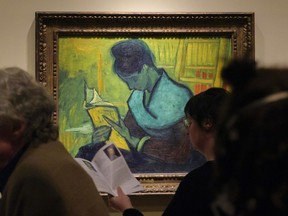 FILE - Visitors file past the Van Gogh painting "Une Liseuse De Romans", also known as "The Novel Reader", during the Van Gogh in America exhibit at the Detroit Institute of Arts, on Jan. 11, 2023, in Detroit. A deal has been reached over control of the 1888 painting by Vincent van Gogh, lawyers said, weeks after the custody fight created public buzz and much tension near the end of a rare U.S. exhibition in Detroit. Brokerarte Capital Partners LLC, which claims to own "The Novel Reader," told a federal appeals court that it reached a confidential settlement with the unnamed lender who had made the art available to the Detroit Institute of Arts.