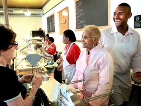 FILE - A customer picks up some food to-go from Sweetie Pie's owner Robbie Montgomery, center, and Montgomery's son, James "Tim" Norman, right, at Sweetie Pie's in St. Louis, April 19, 2011. Norman, the former star of a St. Louis-based television reality show, was sentenced Thursday, March 2, 2023, to life in prison for arranging the shooting death of his nephew to collect a life insurance payment.