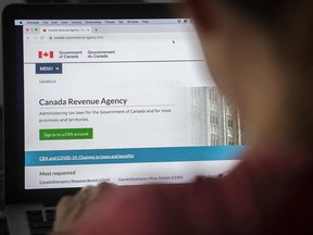A person looks at a Canada Revenue Agency homepage in Montreal.