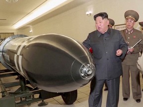 A screen grab shows North Korean leader Kim Jong Un inspecting nuclear warheads at an undisclosed location in this undated still image used in a video.