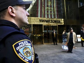 A member of the NYPD stands outside of Trump Tower on Wednesday, March 22, 2023, in New York.