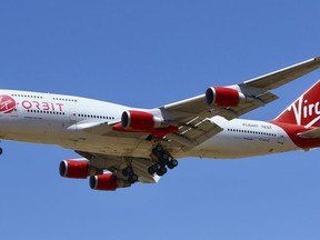 FILE - A Virgin Orbit Boeing 747-400 aircraft named Cosmic Girl prepares to land back at Mojave Air and Space Port in the desert north of Los Angeles Monday, May 25, 2020. Richard Branson's Virgin Orbit is slashing 85% of its workforce, Friday, March 31, 2023, after running into problems with funding less than four months after a mission of the satellite launching company failed.