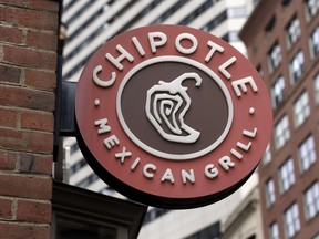 FILE - The Chipotle Mexican Grill logo is seen on a storefront, Friday, Oct. 14, 2022, in Boston. On Monday, March 27, 2023, union officials said Chipotle Mexican Grill has agreed to pay $240,000 to former employees as part of a settlement stemming from a complaint that the company violated federal law by closing a restaurant where workers wanted to unionize.