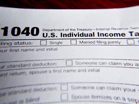 FILE - This Feb. 13, 2019 file photo shows part of a 1040 federal tax form printed from the Internal Revenue Service website, in Zelienople, Pa. It's the first quarter of the year, and many people may be interested in starting side hustles for extra income or to finally pursue their entrepreneurial dreams. Whatever the motivation, it's important to know the implications of starting a side gig while having a 9-to-5 job. This includes understanding how to plan for taxes, budgeting for your side income and deciding how you want your money to work for you.