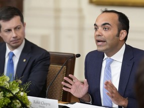 FILE - Rohit Chopra, right, director of the Consumer Financial Protection Bureau, speaks while Transportation Secretary Pete Buttigieg, left, listens as President Joe Biden, not pictured, meets with his Competition Council on the economy and prices in the East Room of the White House, Feb. 1, 2023, in Washington. Banks will need to start reporting the demographics and income of small business loan applicants under new rules published by the Consumer Financial Protection Bureau on Thursday, March 30, 2023.