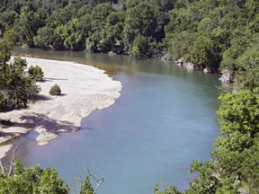FILE - The Illinois River as seen from Goat's Bluffat the J.T. Nickel Family Nature and Wildlife Preserve in Cherokee County, Okla., July 18, 2019. A federal judge is giving Oklahoma and nearly a dozen poultry companies, including the world's largest poultry producer, Tyson Foods, an additional 90 days to reach an agreement on plans to clean a watershed polluted by chicken litter. U.S. District Judge Gregory Frizzell on Friday, March 17, 2023 scheduled a June 16 hearing in Tulsa, saying both sides requested the extension.