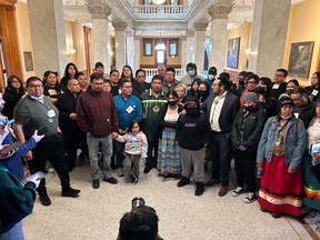 Neskantaga Chief Wayne Moonias, centre in green, speaks alongside First Nations community members during an improvised press conference inside the Ontario Legislature, at Queen's Park, in Toronto, Wednesday, March 29, 2023.