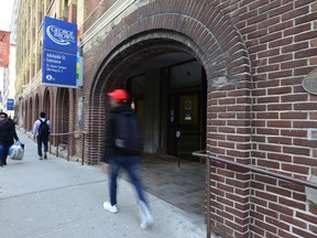 People walk near an entrance to George Brown College in Toronto.
