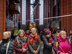 Members of the KFD group, which represents Catholic women in Germany, stand inside the cathedral of Frankfurt, Germany, Thursday, March 9, 2023. They demand equal rights for women in the Catholic Church during the Fifth Synodal Meeting taking place in Frankfurt.