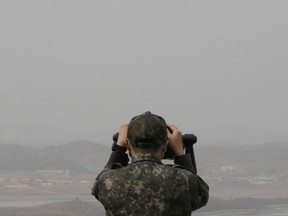 A South Korean army soldier watches the North Korea side from the Unification Observation Post in Paju, South Korea, near the border with North Korea, Friday, March 24, 2023. North Korea said Friday its cruise missile launches this week were part of nuclear attack simulations that also involved a detonation by a purported underwater drone as leader Kim Jong Un vowed to make his rivals "plunge into despair."