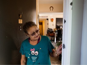 Darlene Blyan looks at the six bullet holes visible in the doorway of her apartment following the shooting deaths of Const. Travis Jordan and Const. Brett Ryan, in Edmonton Monday March 20, 2023. Blyan lives across the hall from the apartment where the two officers responded to a family violence call.