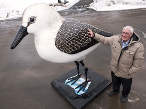Robin Hanson stands with his statue of a semipalmated sandpiper outside of his gallery in French Lake, N.B., on Friday March 24, 2023. The sculpture was commissioned to replace a rotted wooden sandpiper statue in the village of Dorchester.THE CANADIAN PRESS/Stephen MacGillivray