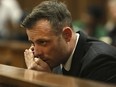 Oscar Pistorius speaks on a mobile phone during his sentencing hearing for murdering girlfriend Reeva Steenkamp in the High Court in Pretoria, South Africa, June 15, 2016.